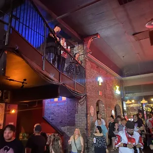 a crowd of people standing and sitting