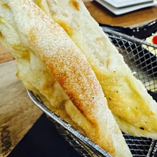 Flatbread that comes with artichoke appetizer.
