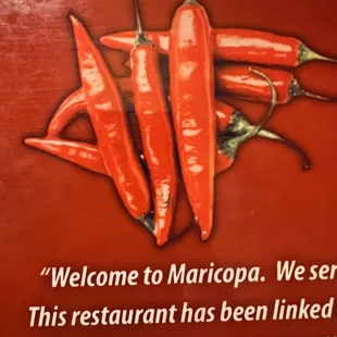 a sign with chili peppers on it