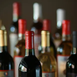 a row of wine bottles on a table