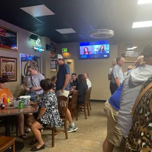 a group of people sitting at tables in a restaurant