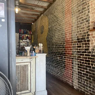 a brick wall with a small counter in front of it