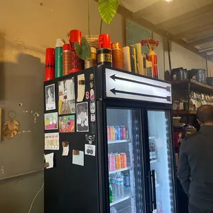 a man standing in front of a refrigerator