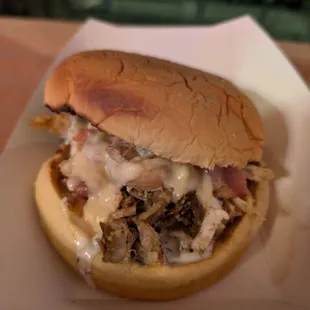 Chicken bacon club with queso on a bun