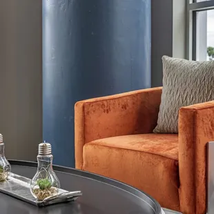 two orange chairs and a black coffee table