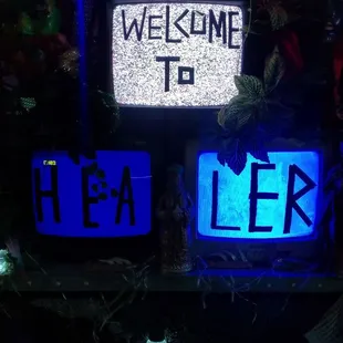 a neon sign with the words welcome to l e r
