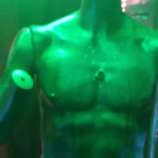 a statue of a man with green paint on his body