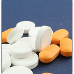 a close up of pills on a blue surface