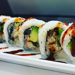 a plate of sushi with sauce