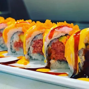 a plate of sushi with sauce and sauce