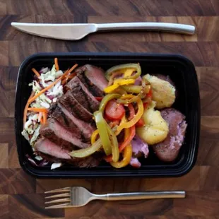 a meal of steak, potatoes, and vegetables