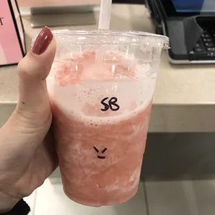a hand holding a smoothie