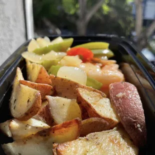 a tray of potatoes, carrots, and peppers