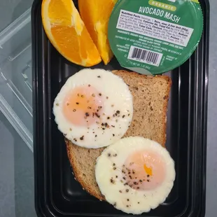 two eggs, toast, and orange slices