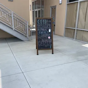 a chalkboard sign in front of a building