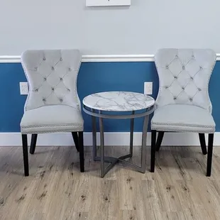 a waiting room with two chairs and a table