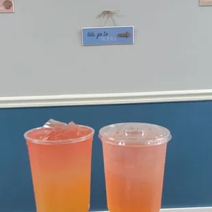 two glasses of orange juice on a counter