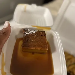 a person holding a container of food