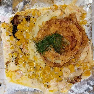 Superdome: Blackened fish topped with mash potatoes with lobster cream sauce, corn, and crispy onion rings.