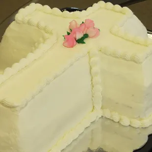 a white cake with a pink rose on top