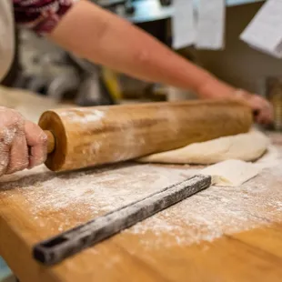a person rolling dough on a table
