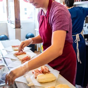 a woman preparing food in a kitchen