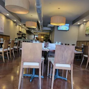 a dining area with tables and chairs