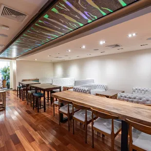 a dining room with a long table and chairs