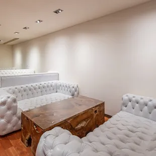 a living room with white furniture