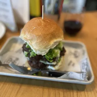 a burger on a plate with a fork