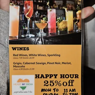 a hand holding a happy hour menu