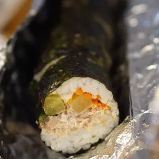a sushi roll wrapped in aluminum foil