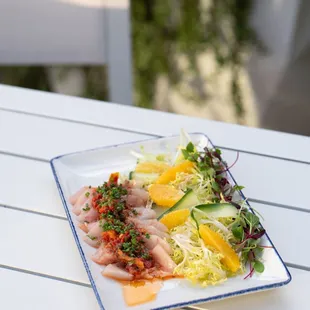 Hiramasa Crudo with frisée, cucumber, sun-dried tomato, &amp; caper vinaigrette