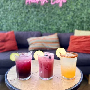 three cocktails on a table