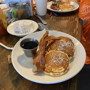 Kids chocolate chip pancakes with bacon and cake with a side of apples. My kids ate this up!