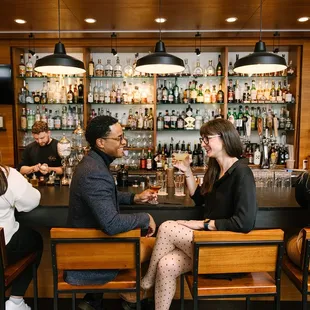 a group of people sitting at a bar