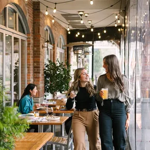 two women walking through a restaurant