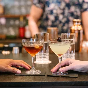 a couple of people sitting at a bar