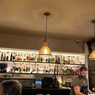 a man behind the bar at a restaurant