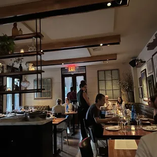 people sitting at tables in a restaurant