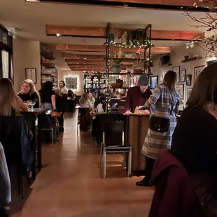 a group of people sitting at tables in a restaurant