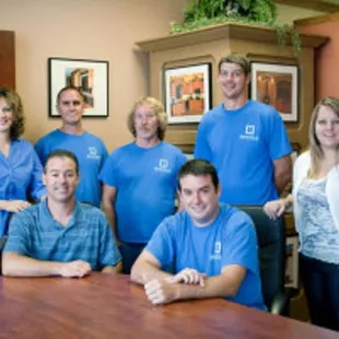 a group of people in blue shirts