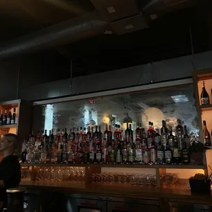 bottles of alcohol lined up on the bar