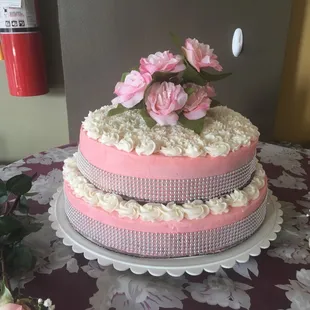 Bridal shower cake with buttercream and adorned with rosettes and fake flowers