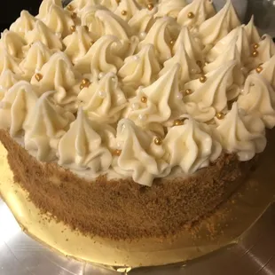 Spice cake with cream cheese frosting, coated in ginger snap crumbs