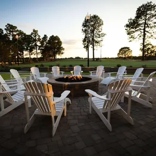 a fire pit surrounded by lawn chairs