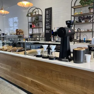 a counter with coffee and pastries
