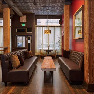 a living room with leather couches and a coffee table