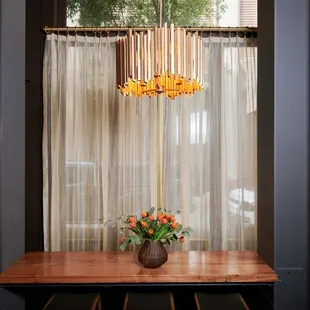 a dining room table with a vase of flowers on it