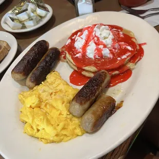 Strawberry pancakes with pork links and eggs